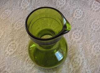 Up for sale is a vintage green glass carafe/pitcher (8.50” x 4.50 