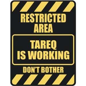   RESTRICTED AREA TAREQ IS WORKING  PARKING SIGN