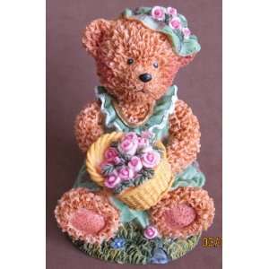 Teddy Bear Statue Sitting Holding a Basket of Flowers  