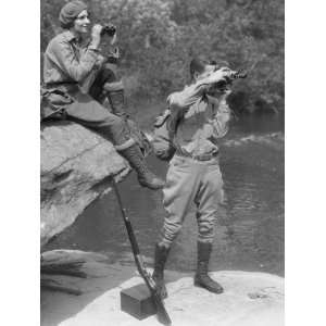  Couple Upland Hunt Near Streamside, With Field Glasses and 