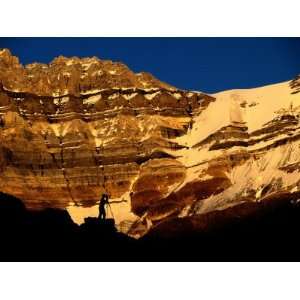  A Photographer is Silhouetted against a Dramatic Mountain 