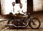 Photo of 2 men with garters on a Vintage Motorcycle  