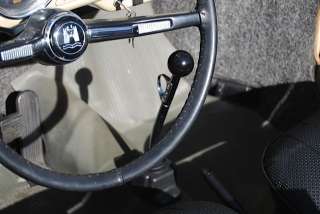 Steering wheel has a well fit cover. Shifter is the classic Trigger 